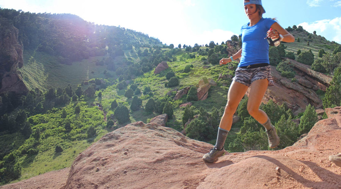 Women trail running wearing Cloudline merino wool socks
