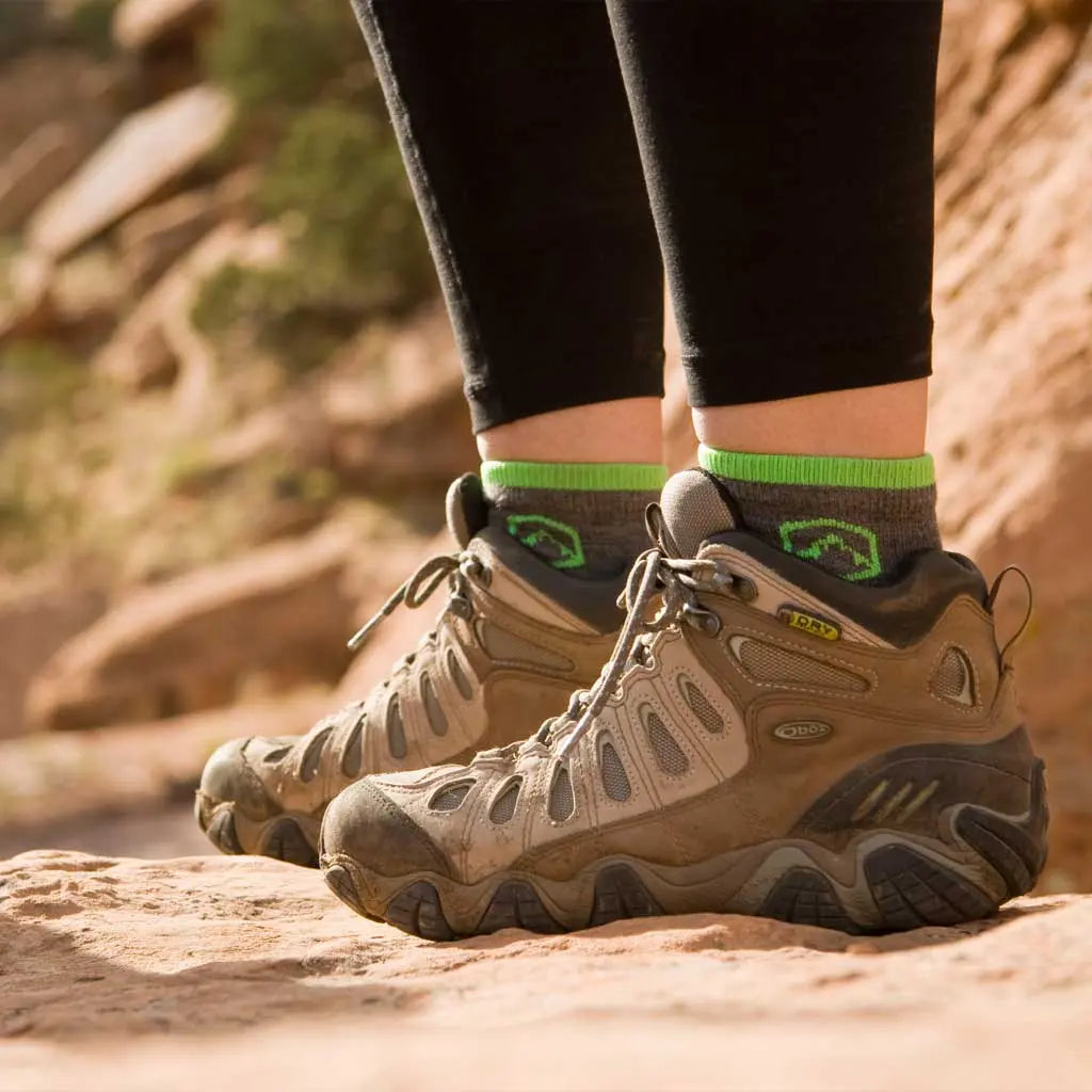 Women standing on sandstone trail wearing Cloudline Quarter Top Merino Wool Running Sock - Light Cushion