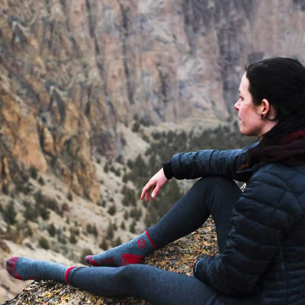 Women sitting on ridge overlooking valley wearing Cloudline 1/4 Top Merino Wool Running Socks