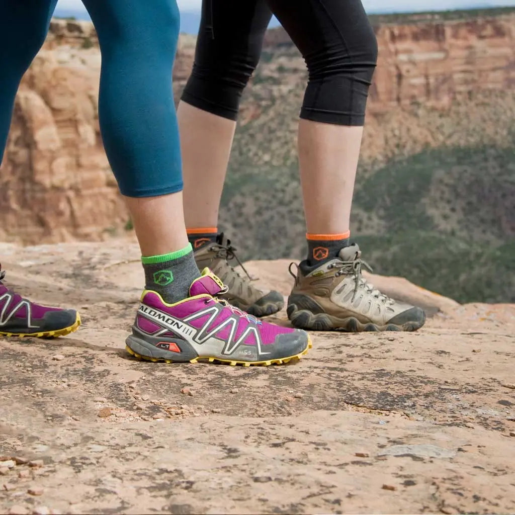 Two hikers standing on canyon rim wearing Cloudline 1/4 top merino wool socks.