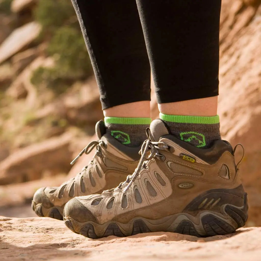 Women standing on rocky trail wearing Cloudline 1/4 top merino wool socks.