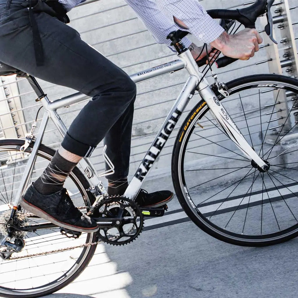 Bike Commuter wearing Cloudline merino wool dress socks while riding road bike