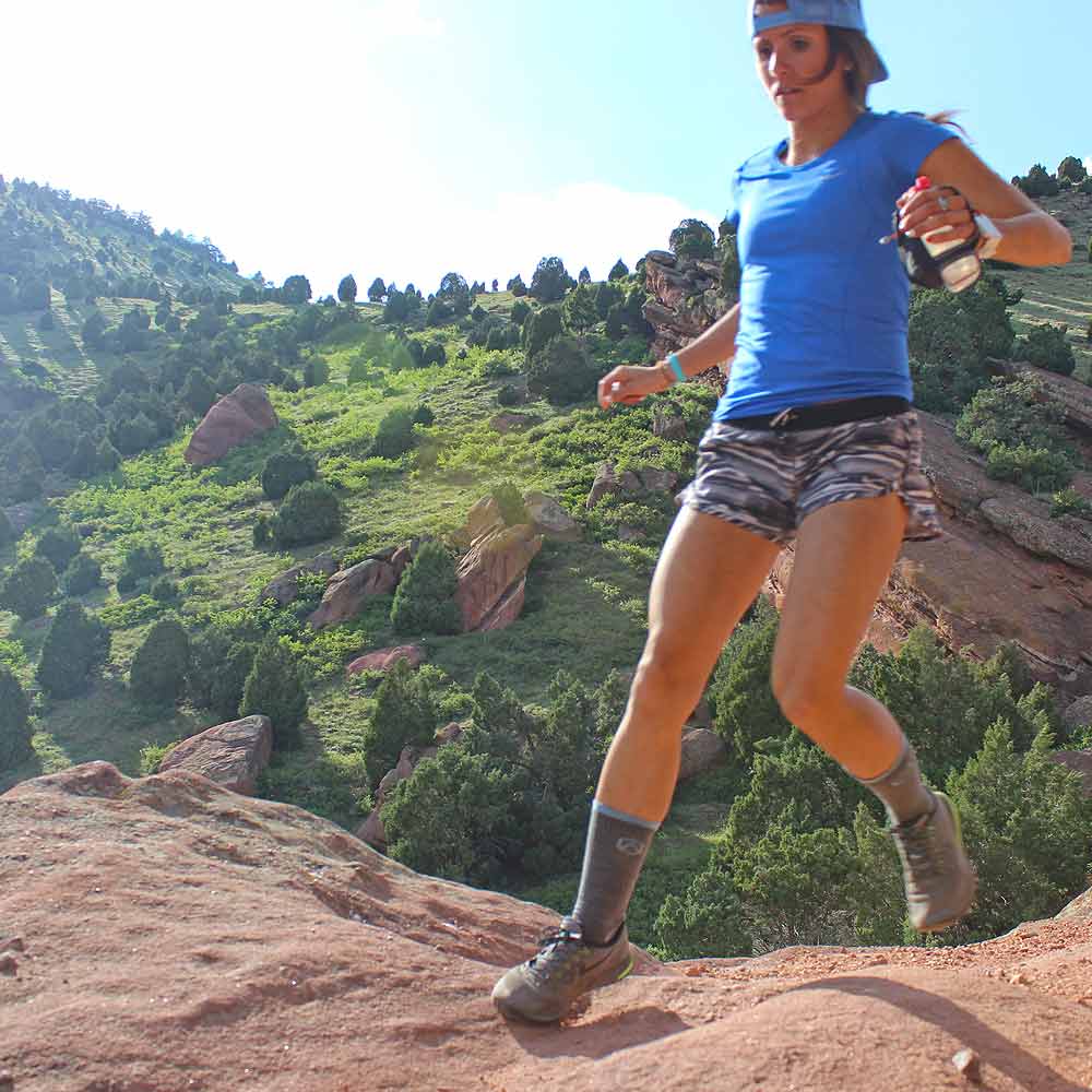 Trail runner wearing Cloudline hiking socks running fast.