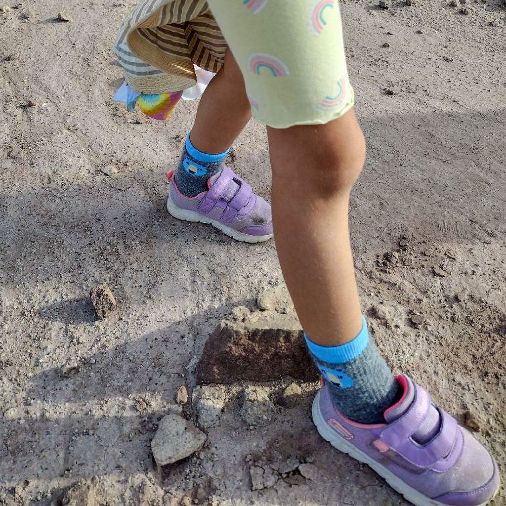 Kid hiking wearing Cloudline blue bear hiking socks. 