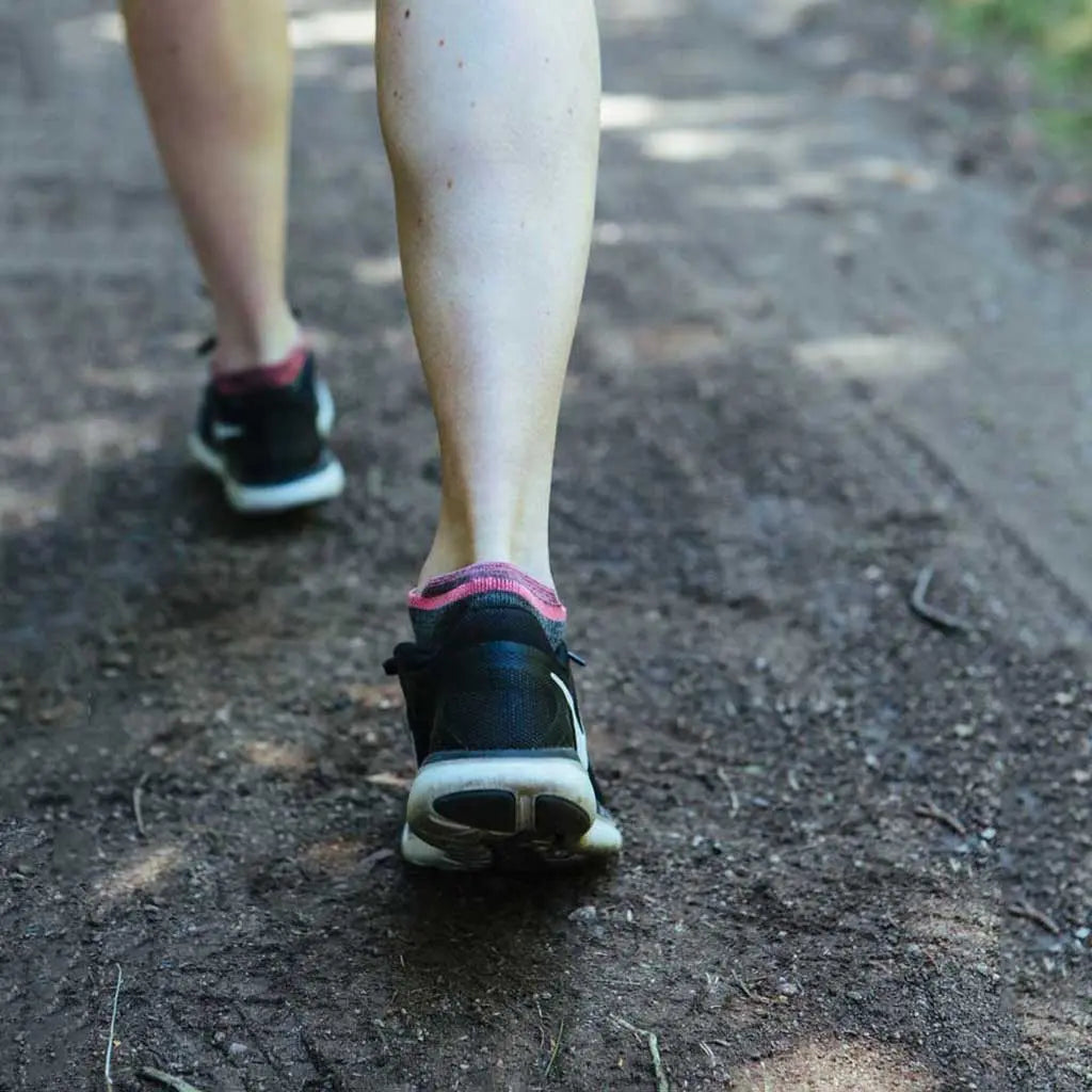Close up of women mid-stride wearing Cloudline merino wool running socks.