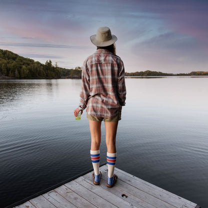 Women wearing Cloudline compression socks standing on dock at sunset with back to camera. 