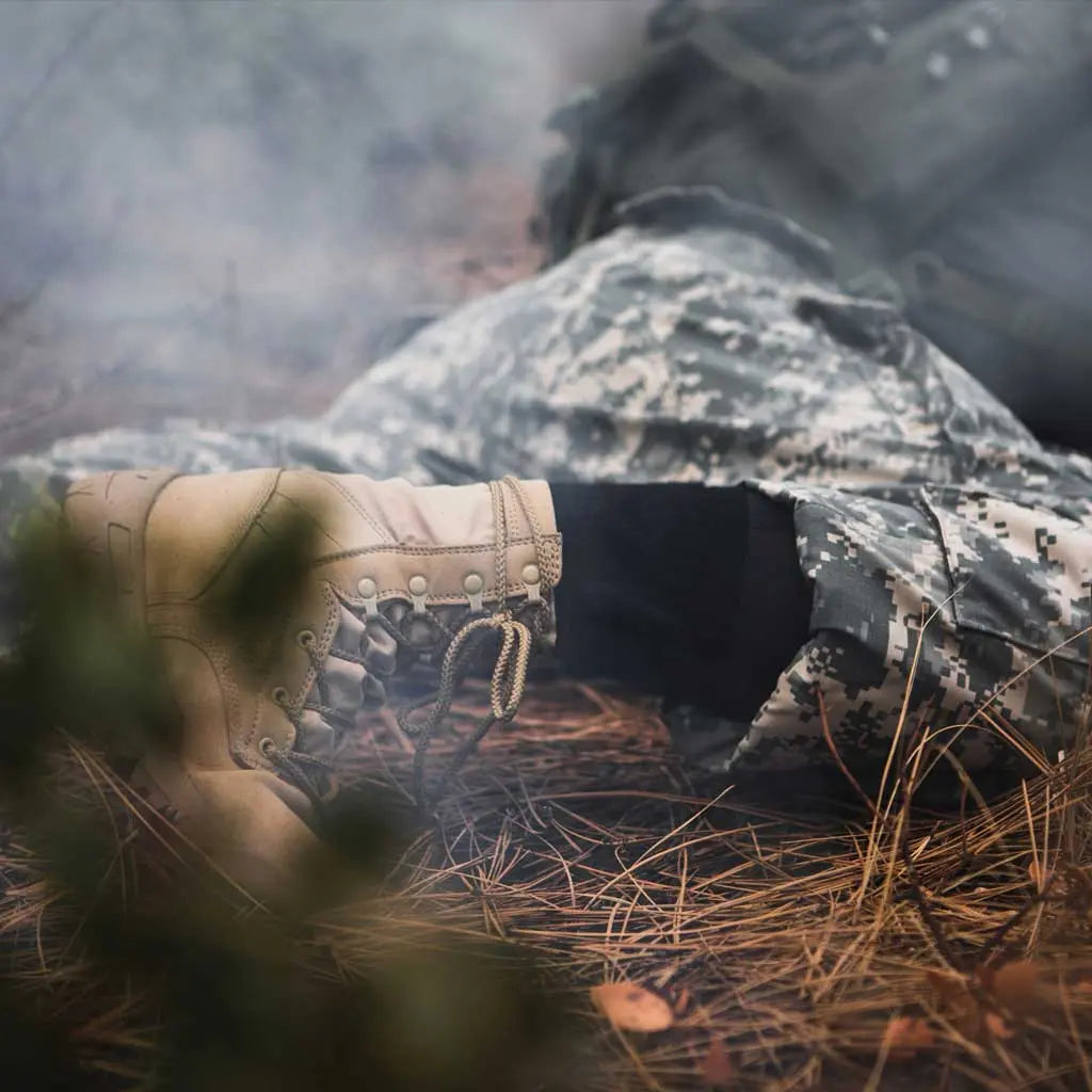 Women wearing Cloudline merino wool tactical socks while crawling under obstacle course.