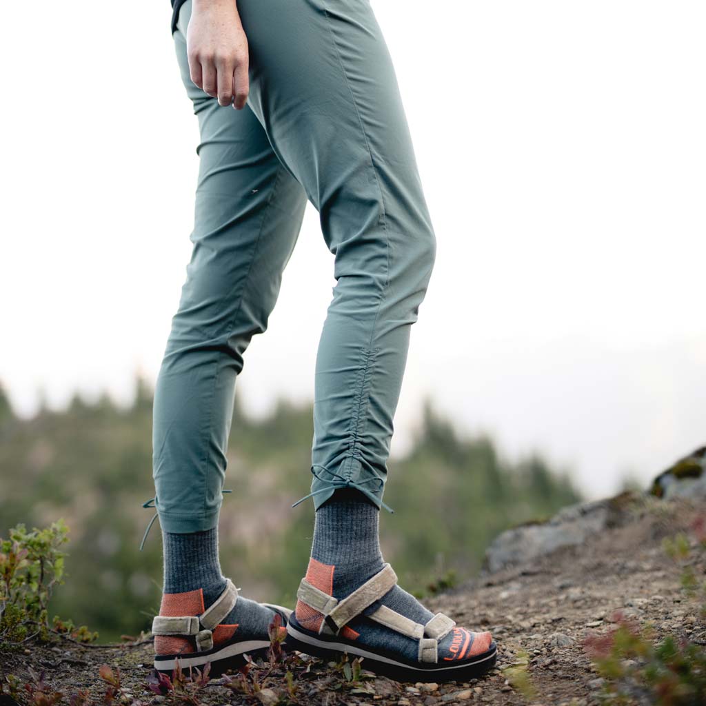 Hiker wearing Cloudline hiking socks and sandals on trail.