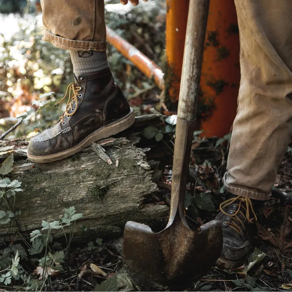 Man wearing Cloudline merino wool work socks while doing trail work.