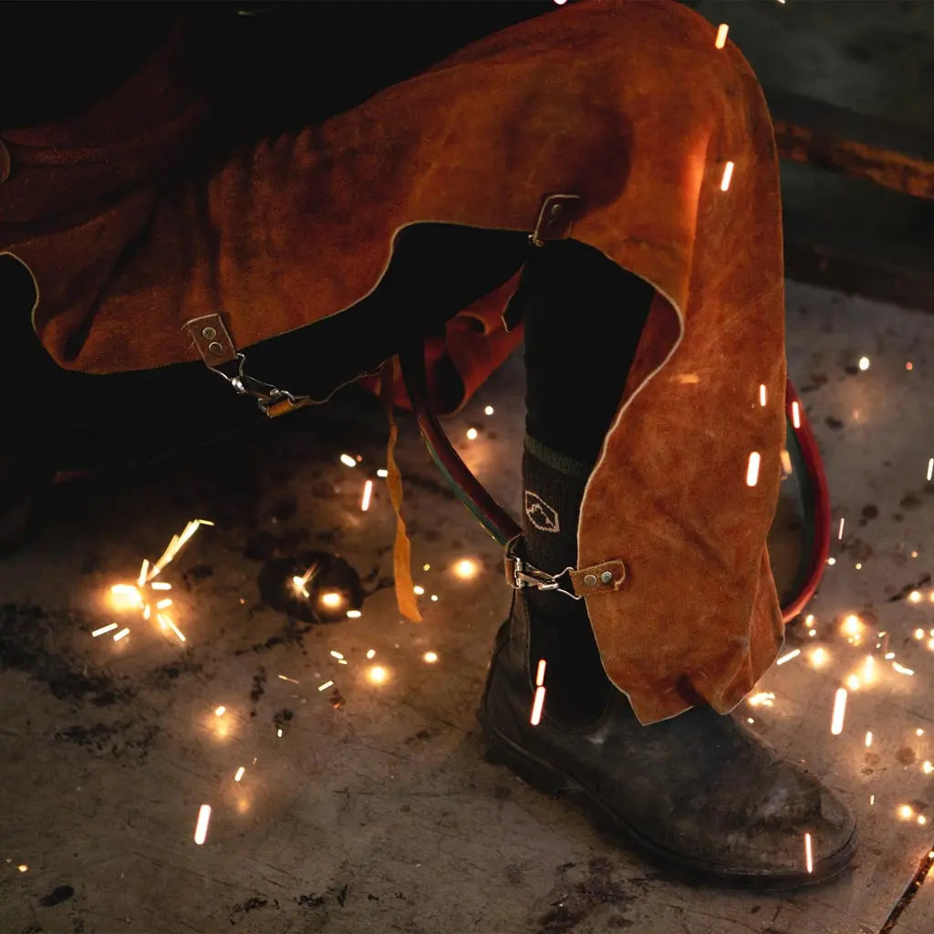 Craftsmen wearing Cloudline merino wool work socks while welding.