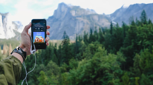 Hiker listening to the Dirtbag Diaries while hiking in the mountains.