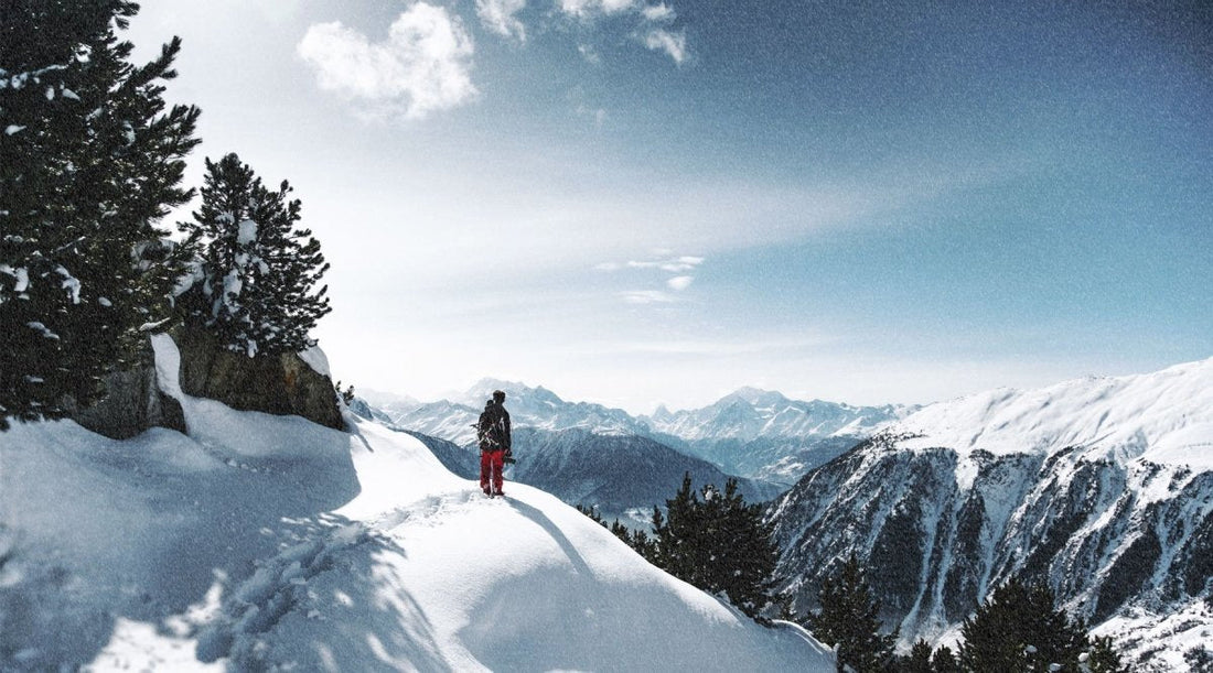 Hiker walking on snowy mountain.
