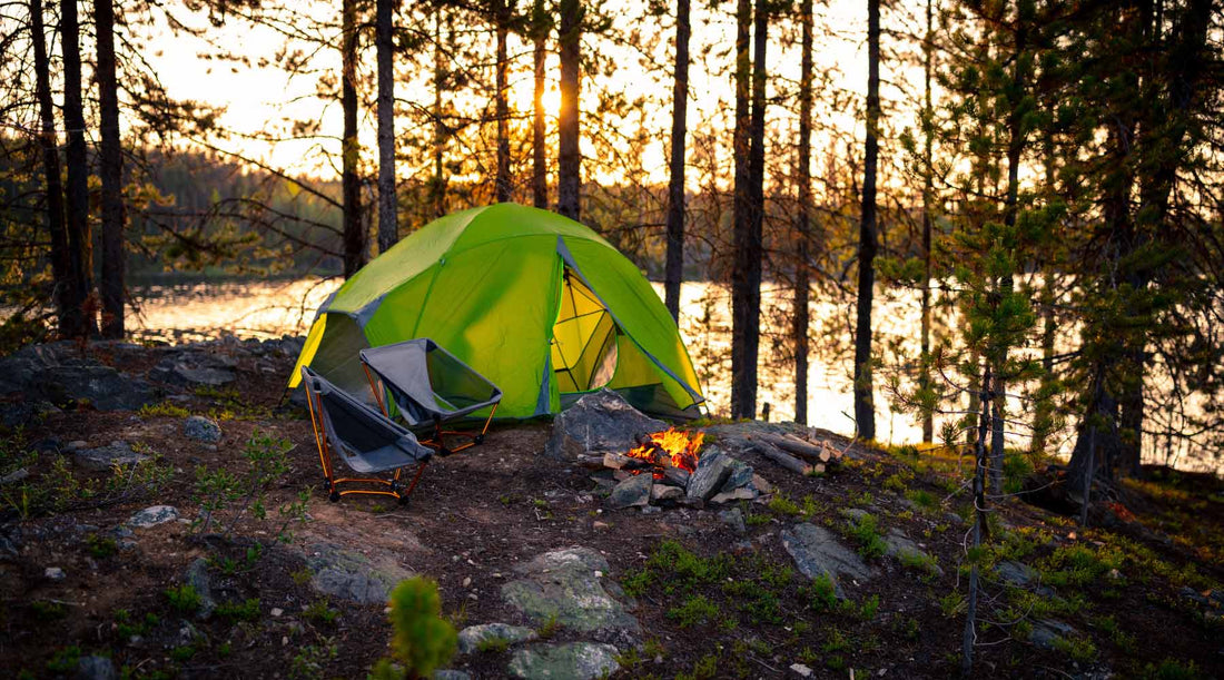 Tent with a campfire in a beautiful lakeside camp site.