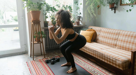 Woman doing squats in her living room.