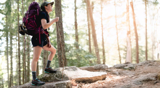 Backpacker wearing Cloudline merino wool socks on hiking trail.