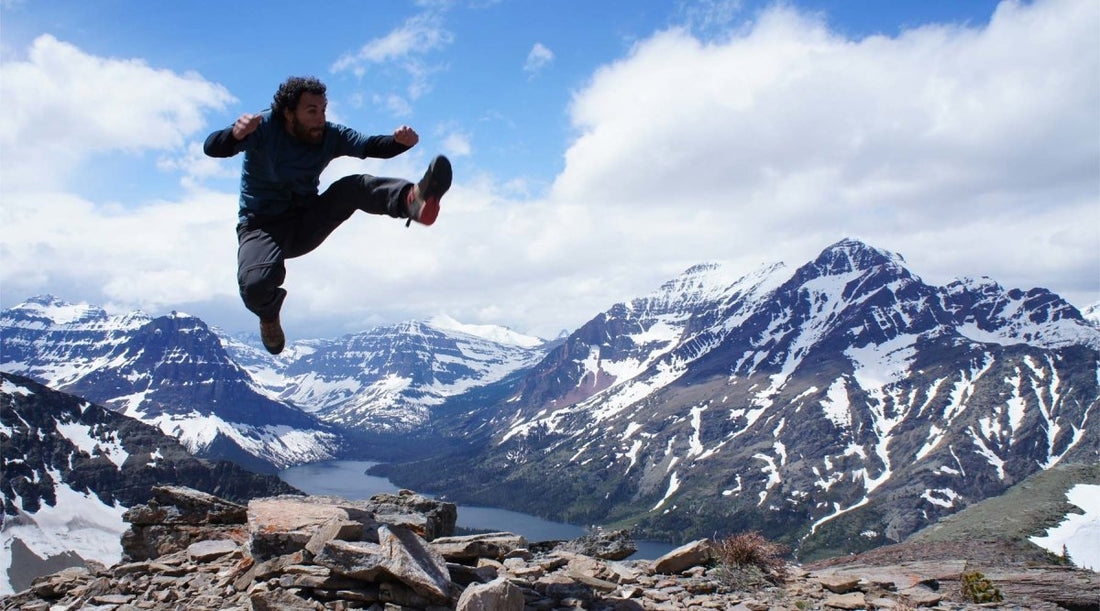 Hiker jumping for joy on a mountain top.