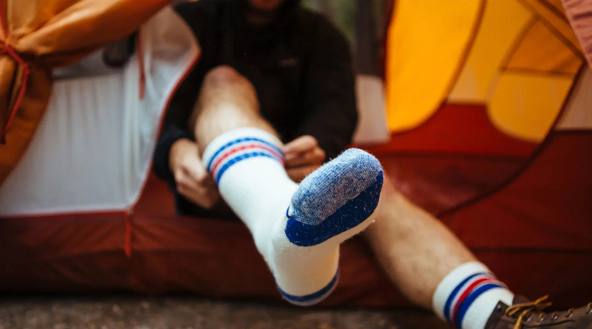 Man wearing Cloudline socks while doing trail work.