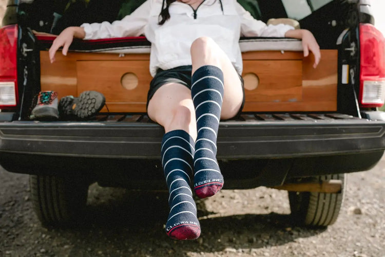 Women wearing Cloudline socks while doing trail work.