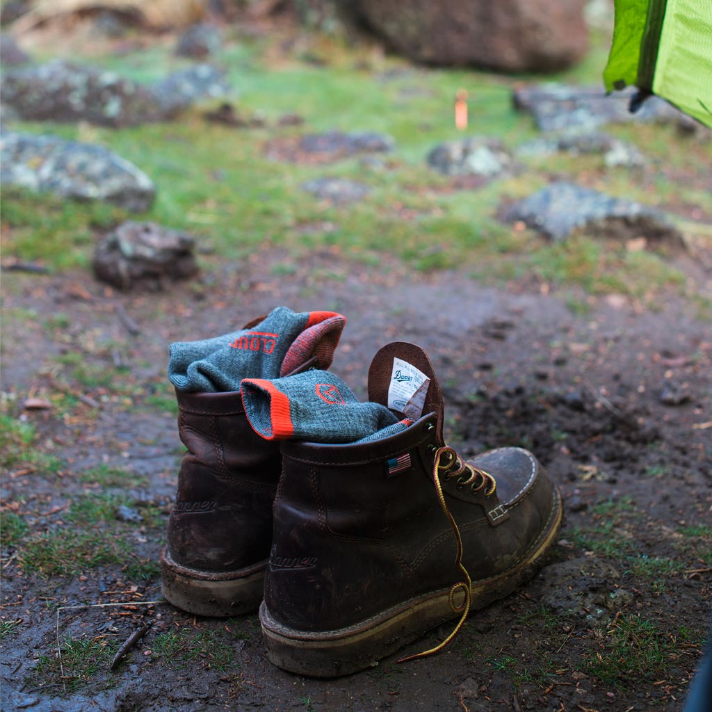 Cloudline socks resting on boots outside tent door. 