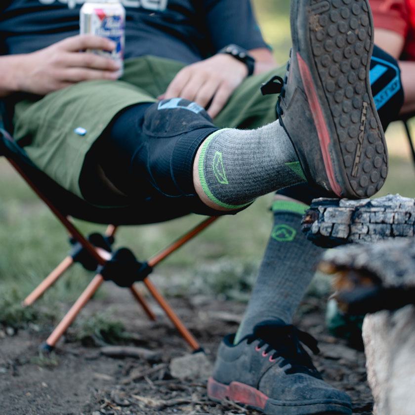 Man sitting in camp chair wearing Cloudline socks
