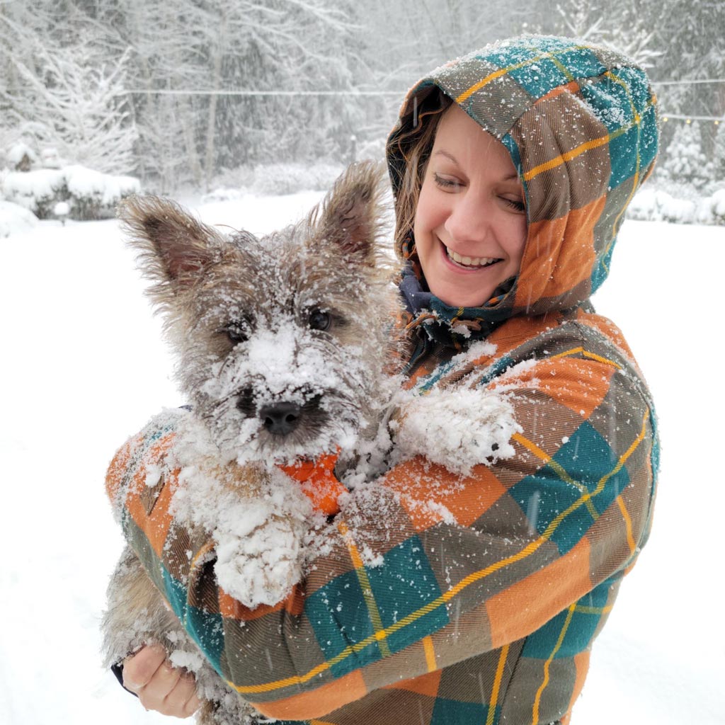 Sara holding her dog in the Snow