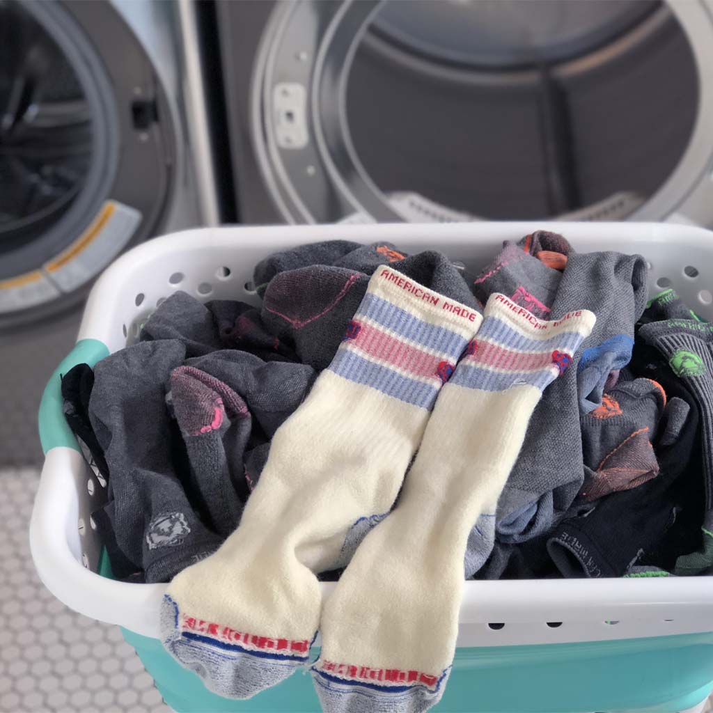 Cloudline socks in a laundry basket turned inside out and ready to go in the washing machine. 