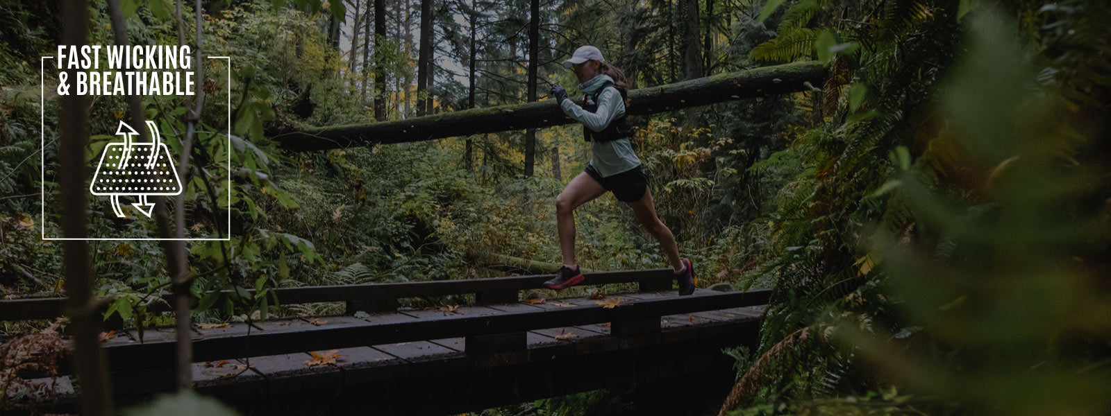 Trail runner wearing Cloudline socks running across wooden trail bridge. 