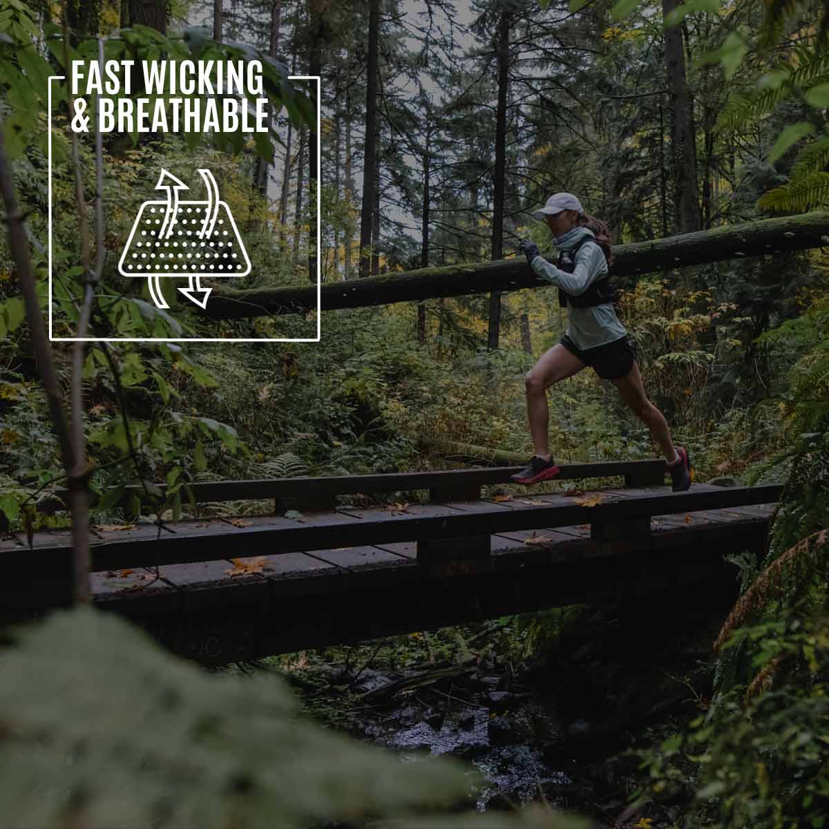 Trail runner wearing Cloudline socks running across wooden trail bridge. 