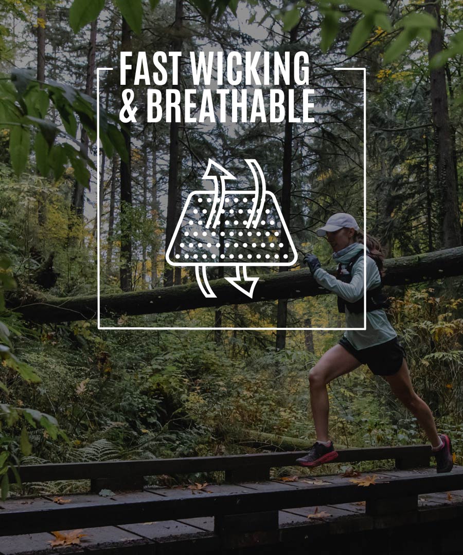 Trail runner wearing Cloudline socks running across wooden trail bridge. 