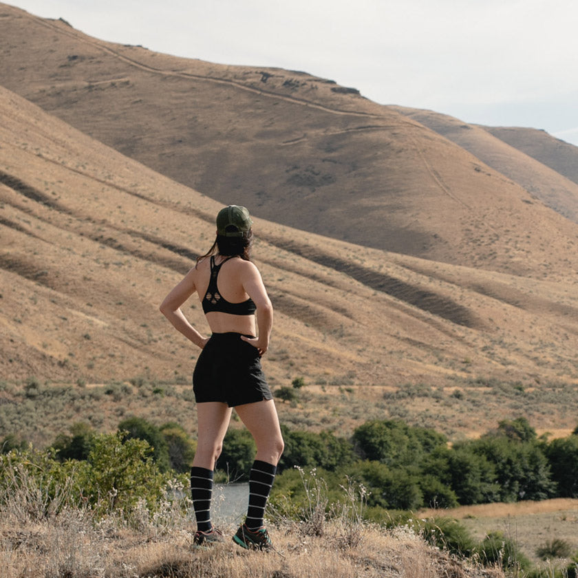 Women wearing Cloudline compression socks on desert trail. 