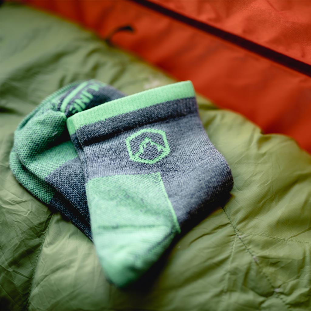 Cloudline 1/4 tops socks neatly folded on sleeping bag inside tent. 