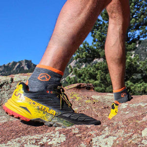 Hiker wearing Cloudline 1/4 socks walking on rocky trail.