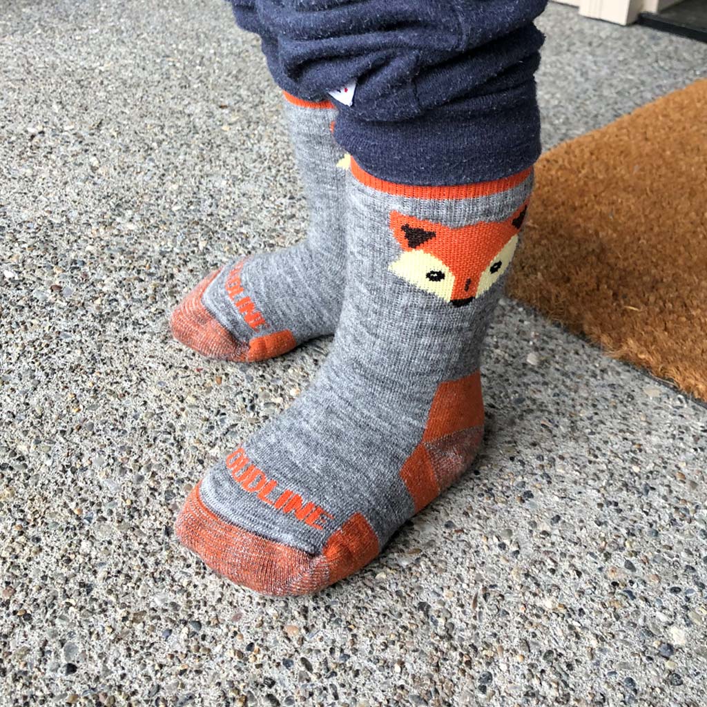 Child wearing Cloudline orange fox hiking socks.