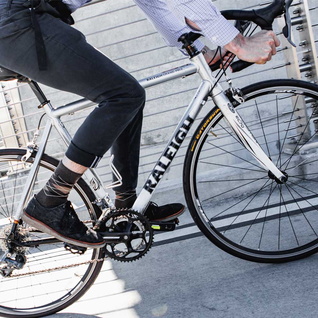 Bike Commuter wearing Cloudline dress socks while riding road bike 