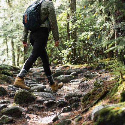 Hiker wearing Cloudline hiking socks on forest trail.