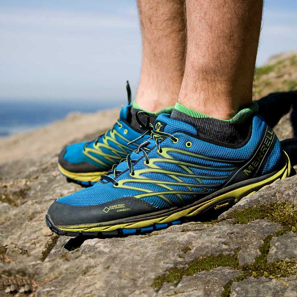 Trail Runner standing on mountain top wearing Cloudline socks. 