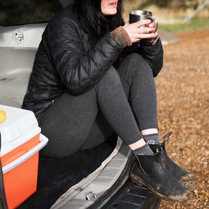Camper sitting on back bumper having coffee wearing Cloudline socks