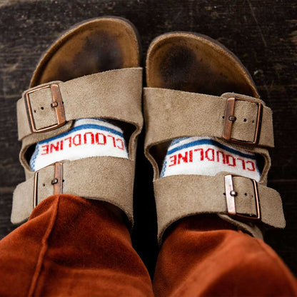 Women wearing Cloudline compression socks wearing her boyfriend's oversized sandals.