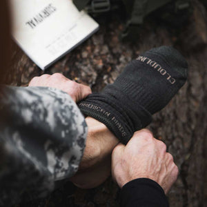 Close up of man pulling on Cloudline tactical socks.