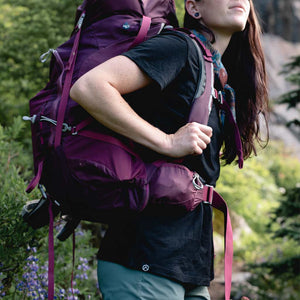 Backpacker wearing Cloudline merino tee on trail.