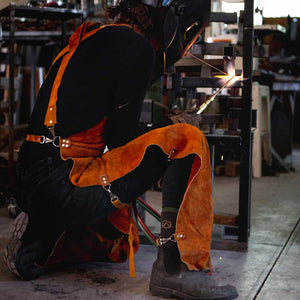 Women wearing Cloudline work socks and welding safety gear while welding. 